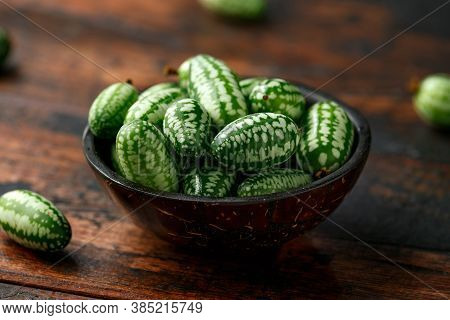 Freshly Picked Cucamelon In Rustic Bowl On Wooden Table