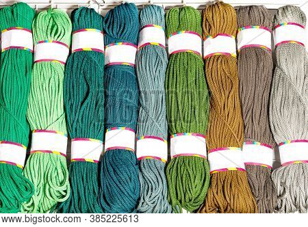 Rolls Of Polyester Cord In Various Bright Colors Of Green And Beige, Rolled Up, Close-up, Copy Space