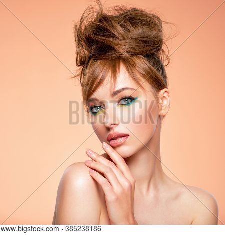 Beautiful girl with trandy makeup. Face of an young girl close-up with a green color makeup. Stylish makeup.