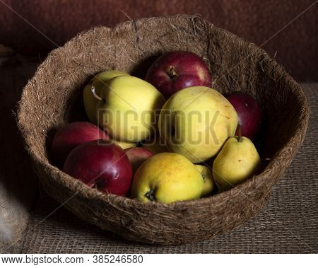 Red And Yellow Apples In The Brown Basket