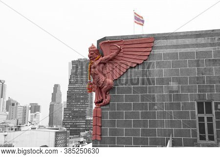 Color Garuda Statue On The Top Of The Black And White Building And Background. A Symbol Of Thailand 