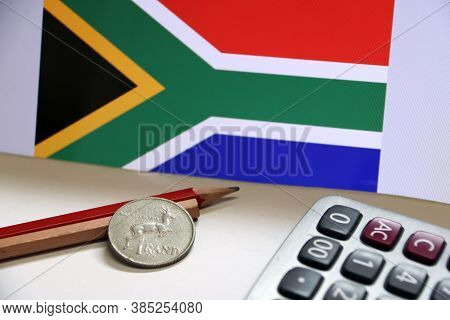 Coin Of South Africa In Reverse Of A Coin With Deer Form On Wooden And Red Pencil With Calculator On