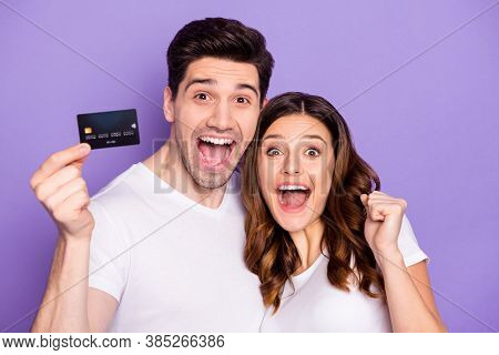 Portrait Of Ecstatic Two Married People Hold Credit Card Win Bank Cashback Service Help Raise Fists 