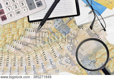 25 Egyptian Piastres Bills And Calculator With Glasses And Pen. Tax Payment Season Concept Or Invest