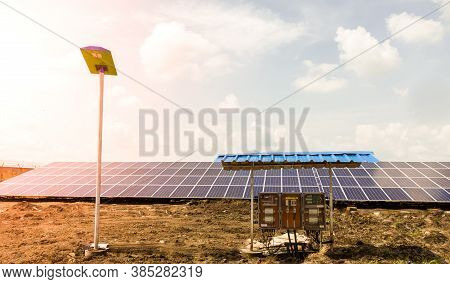 Row Of Installed Photovoltaic Solar Panels Or Modules, Solar Street Light And String Combiner Box, S