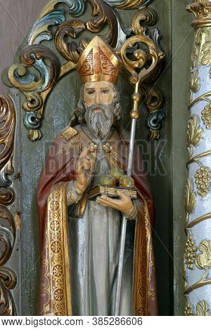 PETROVINA, CROATIA - JULY 22, 2013: Saint Nicholas, statue on the altar of Saint Anthony the Hermit in the parish church of Saint Peter in Petrovina, Croatia