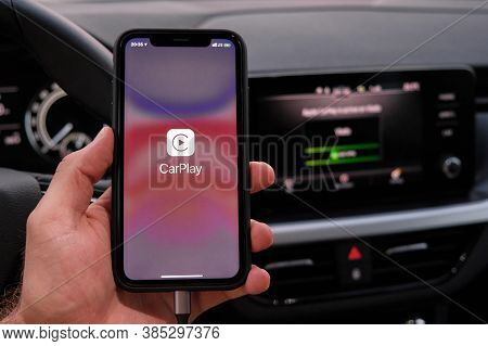 Closeup Mans Hand Holding Iphone With Apple Carplay Logo On The Screen In The Car, September 2020, P