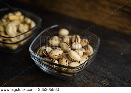 Almond, Cachew And Walnut In A Small Plates Which Standing On A Black Table. Nuts Is A Healthy Veget