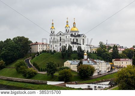 Belarus, Vitebsk - September 10, 2020: Holy Dormition Cathedral On River Bank