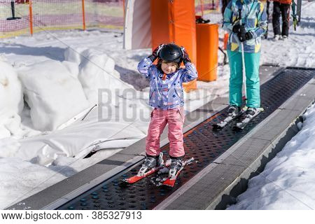 Young, Happy Skier Girl Going Up On Conveyor Lift Belt To Green Ski Zone For Ski Lessons, Bialka Tat