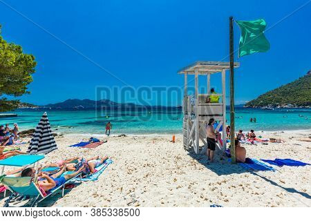 Platja de Formentor, Mallorca, Spain - July 20, 2020: People enjoying the popular beach in summer, Mallorca, Spain.