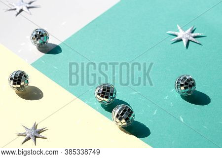 Mirror Balls And Silver Xmas Stars On Mint Green And Yellow Layered Paper. Geometric Christmas Backg