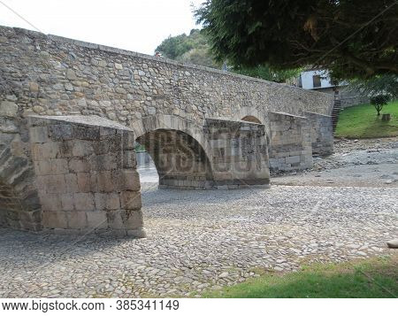 Ancient Roman Bridge Over Meruelo River In Molinaseca, Leon, Spain. Camino De Santiago Goes There.