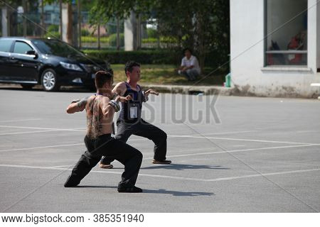 Hanoi, Vietnam - Aug 9, 2015: Vietnamese pugilists in traditional costume doing a performance of mar
