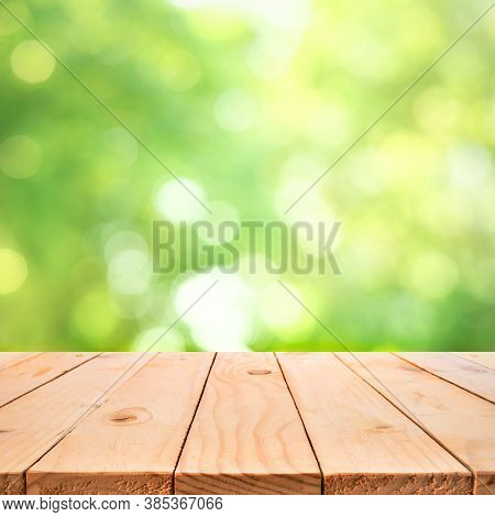 Real Wood Table Top Texture On Blur Leaf Tree Garden Background.for Create Product Display Or Design