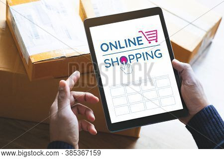 Online Shopping Concepts With Youngman Using Tablet On Product Package Box.ecommerce Market.transpor