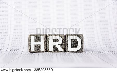 Three Stone Cubes On The Background Of White Financial Statements, Tables With The Word Hrd Human Re
