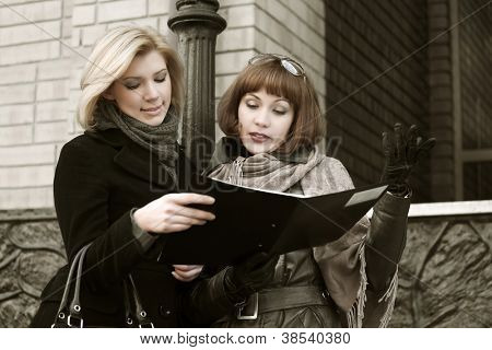 Young businesswomen with a floder