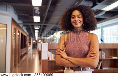African Businesswoman Standing With Arms Crossed Smiling To Camera In Casual Office