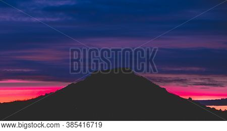 Landscape Of A Sunset With Bright Colors And A Mountain With A Backlight