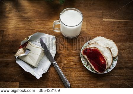 Breakfast: A Group Of Toasts With Butter, Jam And Milk