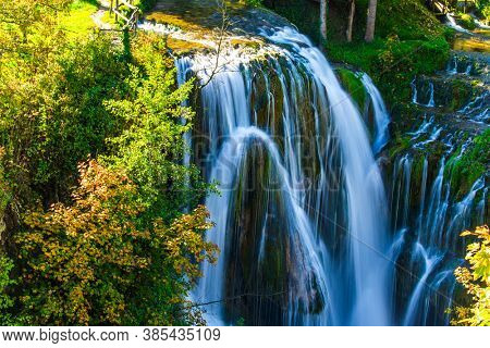 Travel to Croatia. The town of Slunj. Magnificent cascade of waterfalls on the Korana River. Magnificent forests surround the city and the river. The concept of ecological, active and photo tourism