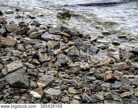 Rocky Shore Of Lake Uvildy In Inclement Weather
