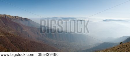 Scenic Panoramic View From The Mountain Vlasic, A Valley Filled With Fog And Peaks Above The Fog In 