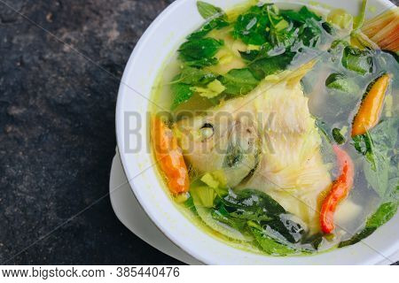 Gurame Fish Head Soup Or Sup Kepala Ikan Gurame With Basil Leaves, Tomatoes, Yellow Curry, And Chill