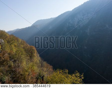 Rays Of Light In The Mist Above The Canyon Of The Ugar River In Autumn During A Sunny Day.