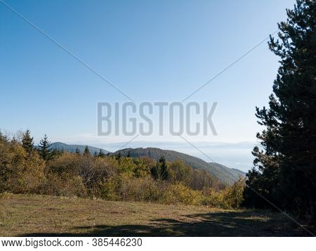 Scenic View From Kozara Mountain To The Valley Filled With Fog And Smoke During A Sunny Day.