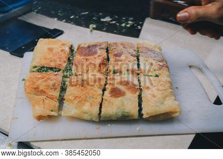 Martabak Telor Or Omelette Martabak. Savoury Pan-fried Pastry Stuffed With Egg, Meat And Spices. Tra