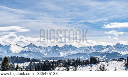 Panoramic View On Snowy Forest And Tatra Mountains In Winter Time. Ski Slopes And Ski Lifts In Bialk