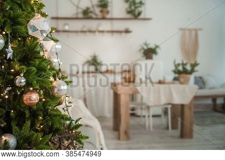 Christmas Tree In The Interior In Defocus. Background For A Christmas Card In Light Colors Inerier.