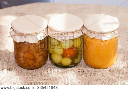 Glass Jurs Of Various Preserved, Canned Foon In The Kitchen In Sunny Day.