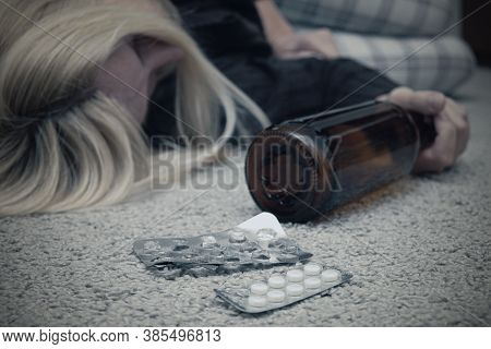 A Woman Committed Suicide By Overdosing And Died On The Floor With Empty Blister Of Pills And A Bott