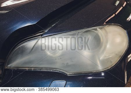 Car Headlights Cleaning With Power Buffer Machine At Car Service.