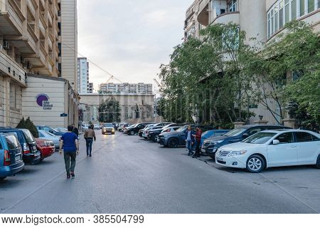 Baku Azerbaijan - May 2 2019: Azeri Men In Front Fo Atlas Medical Center And Damir Bank Office Surro