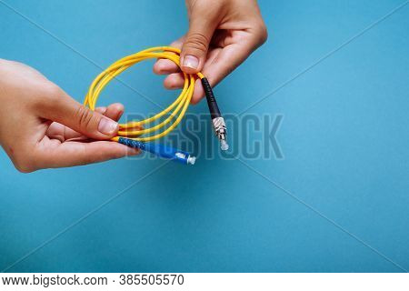 Womans Hands Hold Sc And Fc Connector Fiber Optic Patch Cord Single Mode On Blue Background