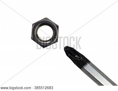 Conceptual Photo Of A Nut And Screwdriver On A White Background. Antipode