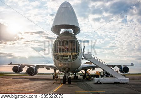 Unloading Widebody Cargo Airplane At The Airport