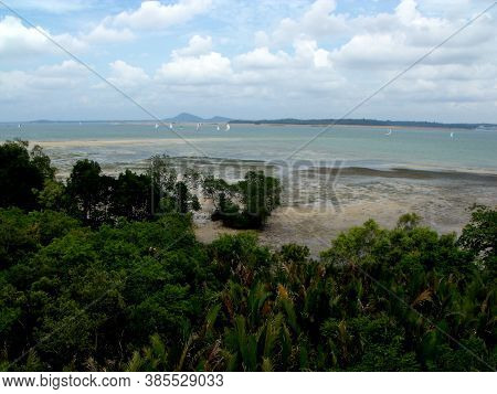 Pulau Ubin, Singapore, March 5, 2016: View Of Singapore From A Beach In Pulau Ubin