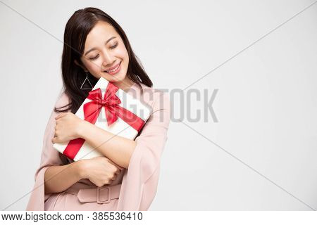 Happy Beautiful Asian Woman Smile And Hugging Gift Box Isolated On White Background. Teenage Girls I