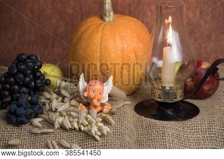 African-american Angel, Small Lamp, Candles And Pumpkin.  Halloween Holiday Concept