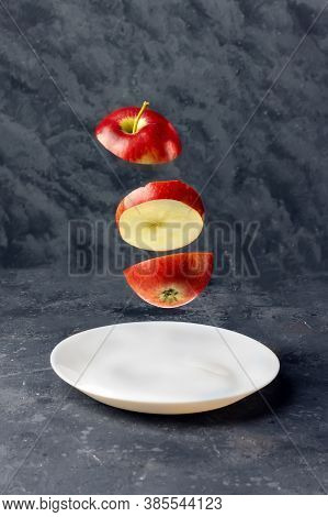 Flying Slice Of Red Apple On Dark Background With Clipping Path. Levity Fruit