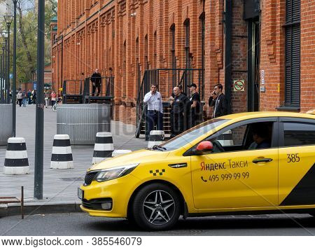 Moscow, Russia - August 16, 2019: 1-ya Miusskaya Street. Food Corner Depo. Yellow Taxi On The Street