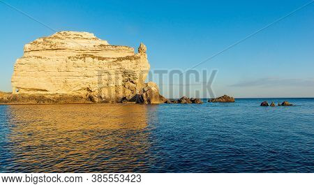Seascape, A Large Rock In The Form Of A Ship Against The Background Of A Clear Blue Sky And Blue Sea