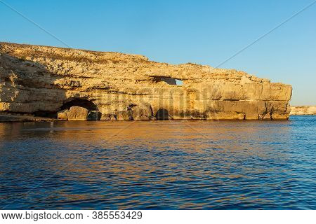 Seascape, A Large Rock In The Form Of A Crocodiles Head Against The Background Of A Clear Blue Sky A