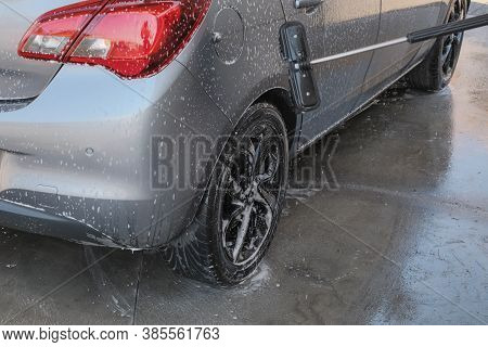 Worker Cleaning Car With A Special Brush And Detersive Close-up. Car Wash Service/business. Self-ser