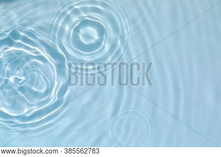 Blurred Transparent Blue Colored Clear Calm Water Surface Texture With Splashes And Bubbles. Trendy 